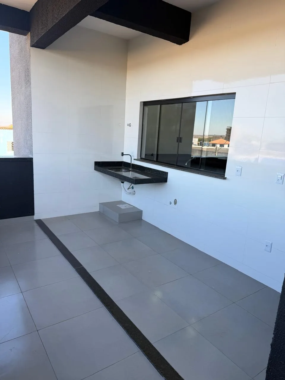 Área de serviço ampla com bancada e janela grande